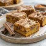 Vegan Pumpkin Dump Cake Bars – Simple, Warm, and Comforting 12 vegan pumpkin dump cake bars on plate