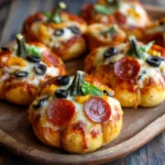 Close-up of mini pumpkin pizza on wooden board