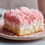 Haunted Pink Coconut Snowball Cake Bars – Spooky Halloween Treats 12 Pink coconut snowball cake bars on a plate