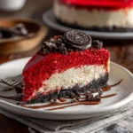 Slice of red velvet Oreo cheesecake on a white plate