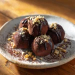 Dark chocolate gluten free truffle on ceramic plate