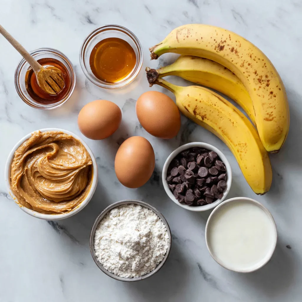 Ingredients for peanut butter banana bread on marble counter