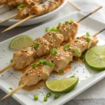 Bang Bang Chicken Skewers plated with sauce