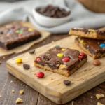 Crispy brownie brittle stacked on wooden board